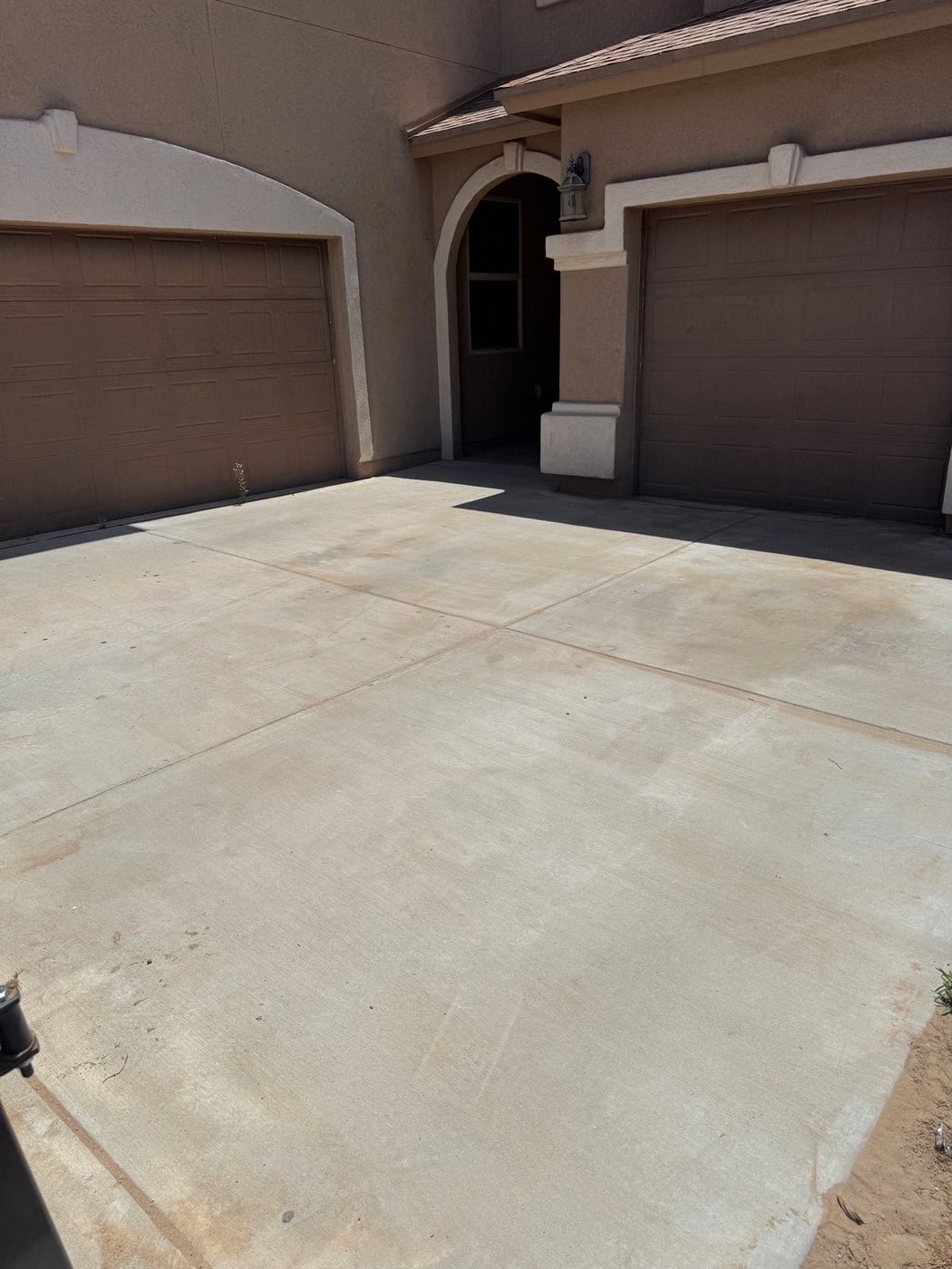 Clean residential concrete driveway in El Paso after pressure washing