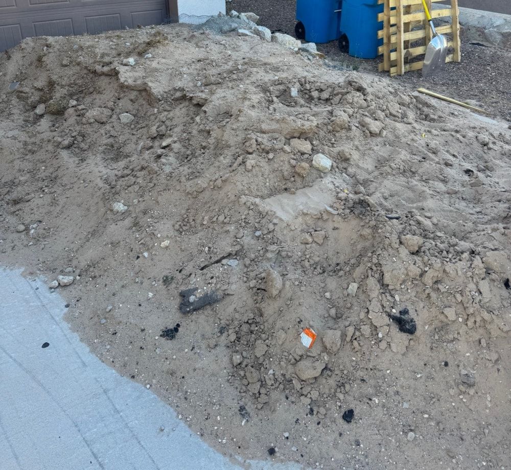 Pile of dirt and construction debris in an El Paso driveway before removal